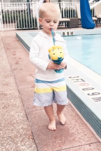 little mermaid pool party - toddler boy drinking from flounder drink cup