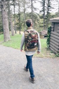 fall activities for kids in connecticut - man in camo backpacking hiking