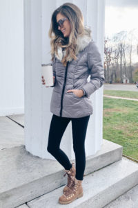 Silver faux fur collar long jacket with black leggings and brown shearling lace up winter boots
