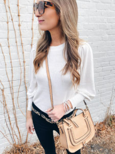 Ann Taylor winter white balloon sleeve sweater with black Ponte 5 pocket pants leopard belt and Victoria Emerson wrap bracelet