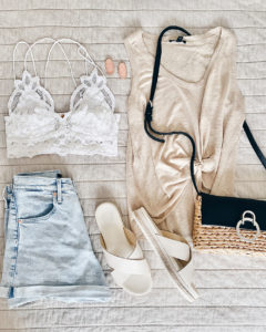 flat lay - beige linen tank high waist jean shorts and summer accessories