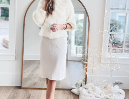 winter white holiday party outfit with white sweater over slip dress