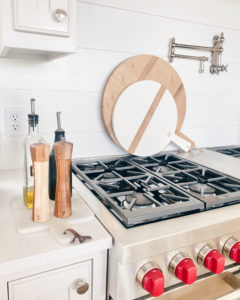 round serving boards on wolf stove kitchen backsplash