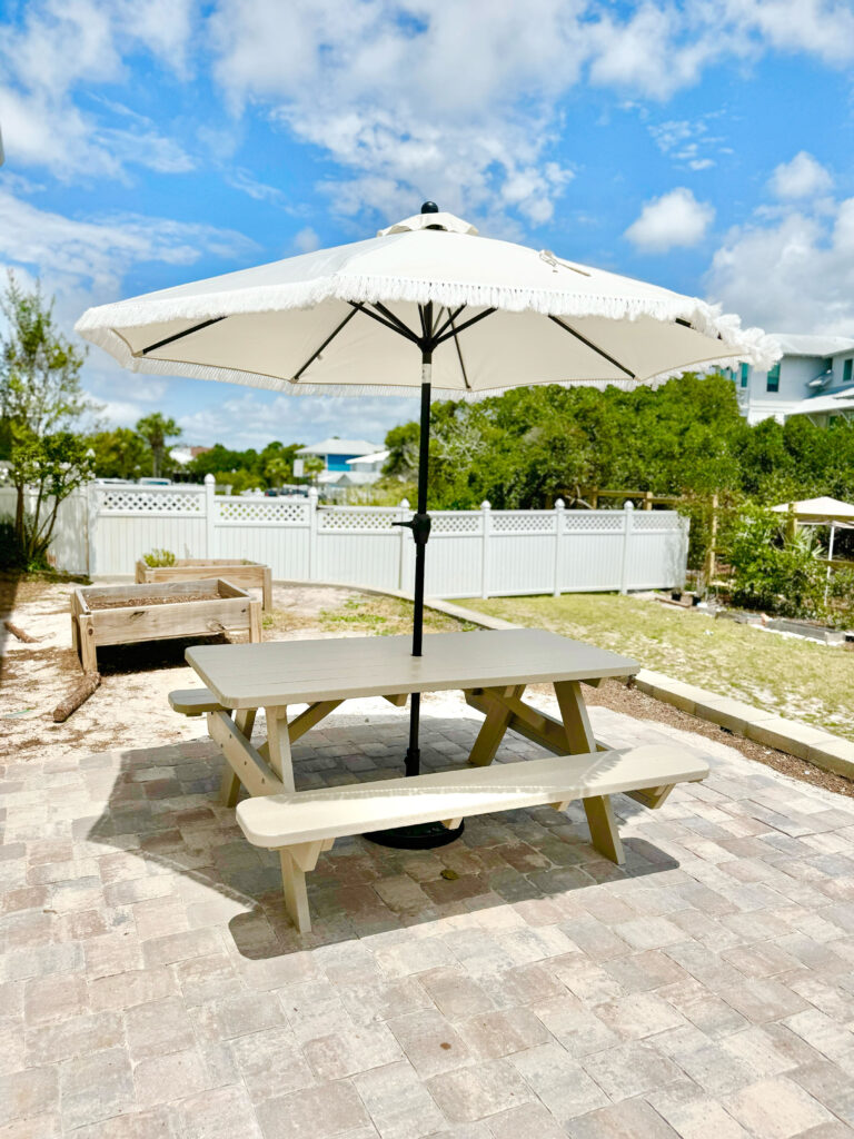 neutral picnic table with large outdoor umbrella