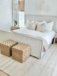 neutral primary bedroom with a jute area rug from wayfair