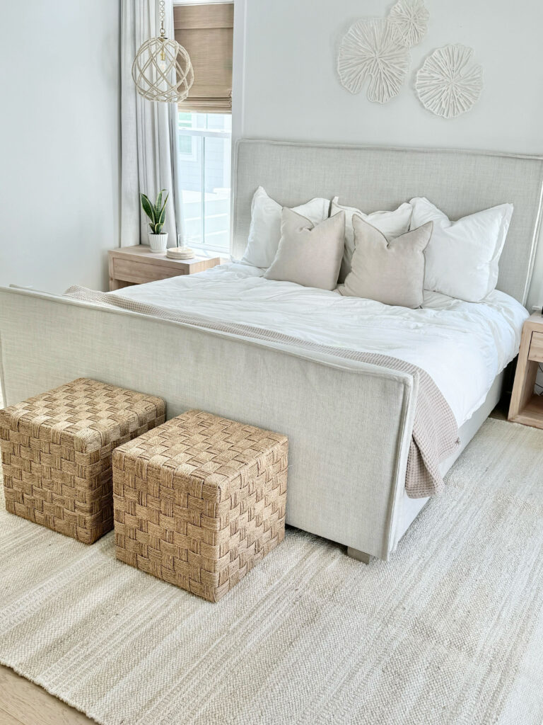 neutral primary bedroom  with a jute area rug from wayfair